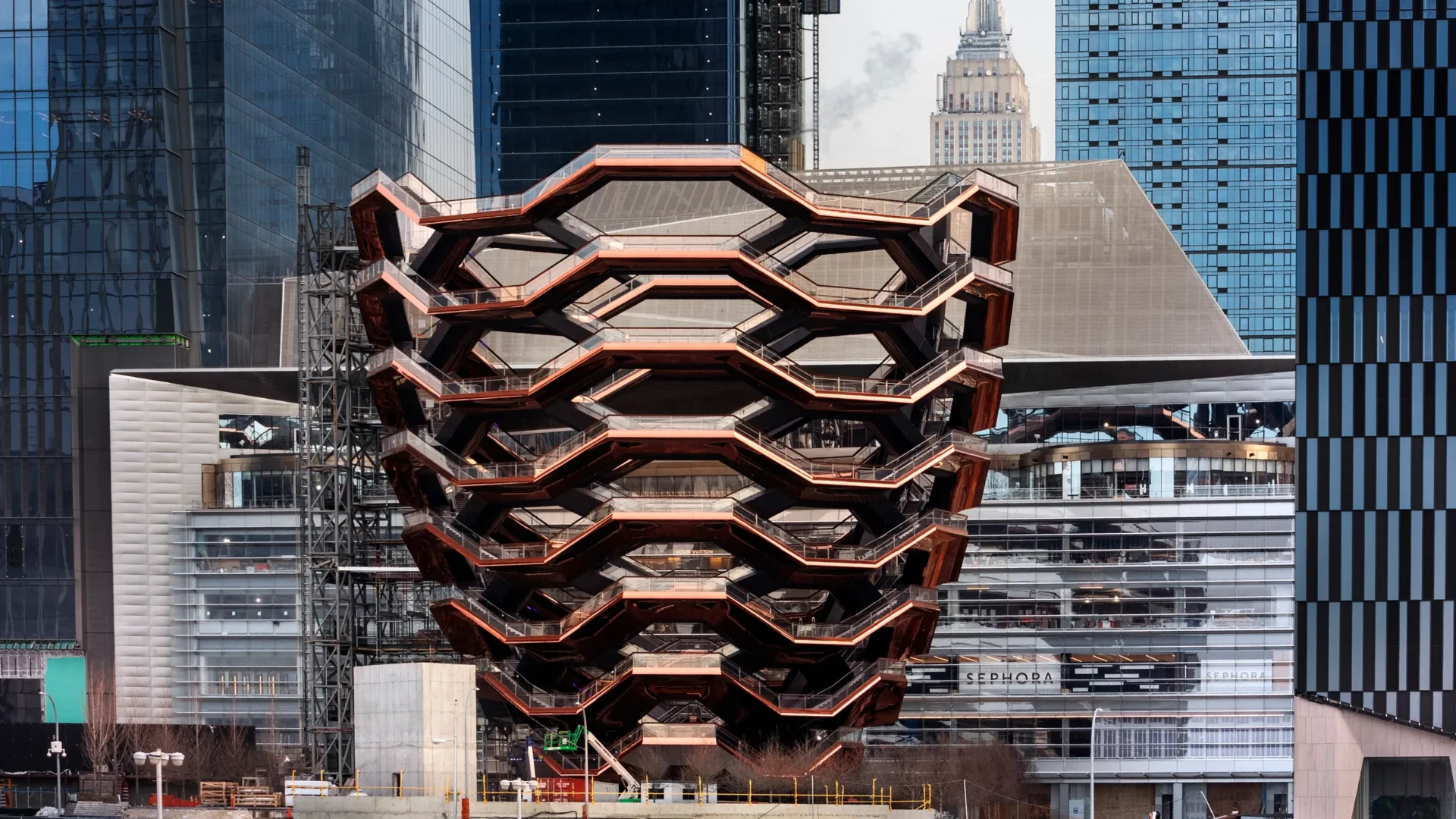 The neighborhood attracts millions of visitors who come to explore its unique design and attractions. One of its most famous landmarks is Vessel, a honeycomb-shaped architectura