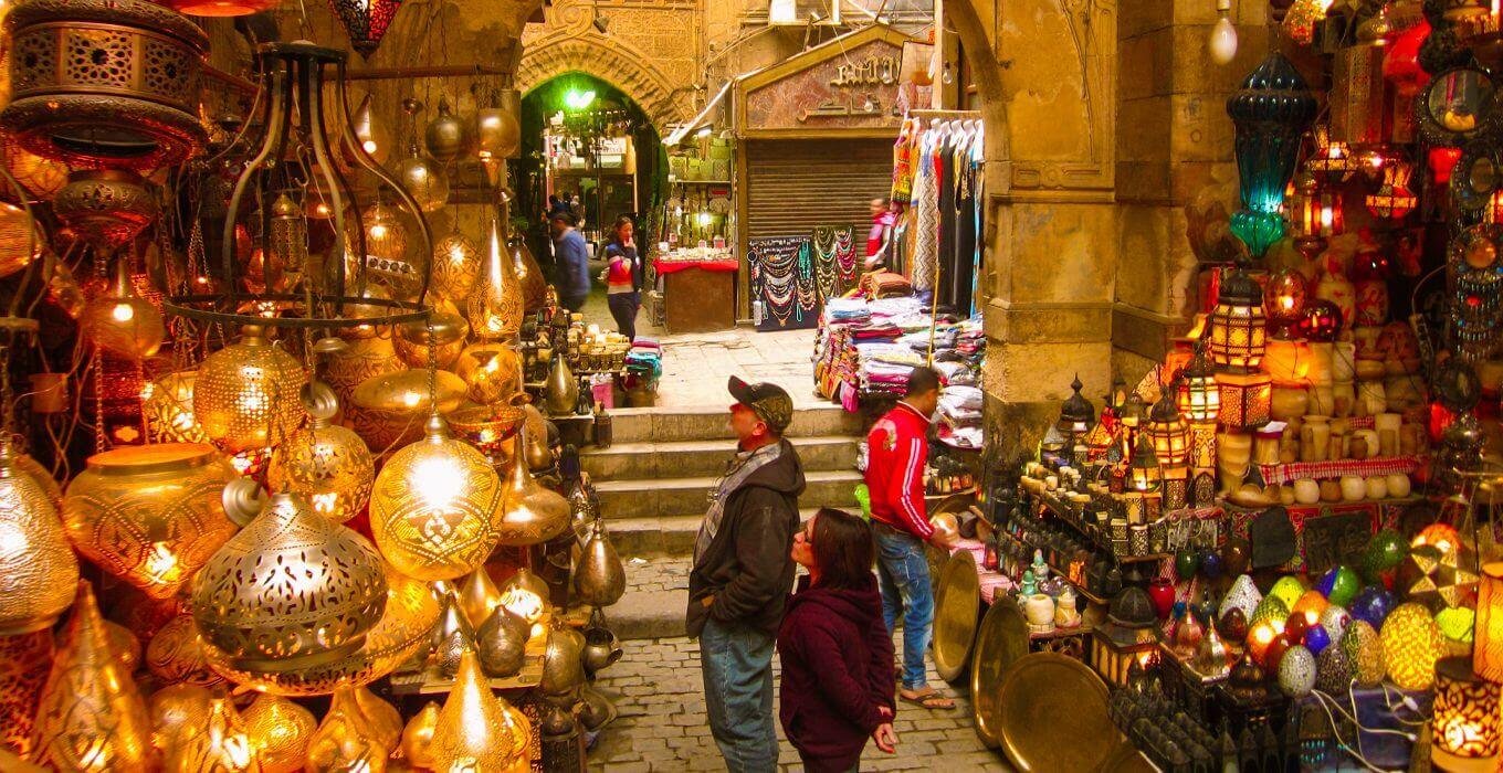 Travelers can explore narrow streets filled with shops selling handmade crafts, jewelry, spices, perfumes, traditional clothing, souvenirs, and Egyptian