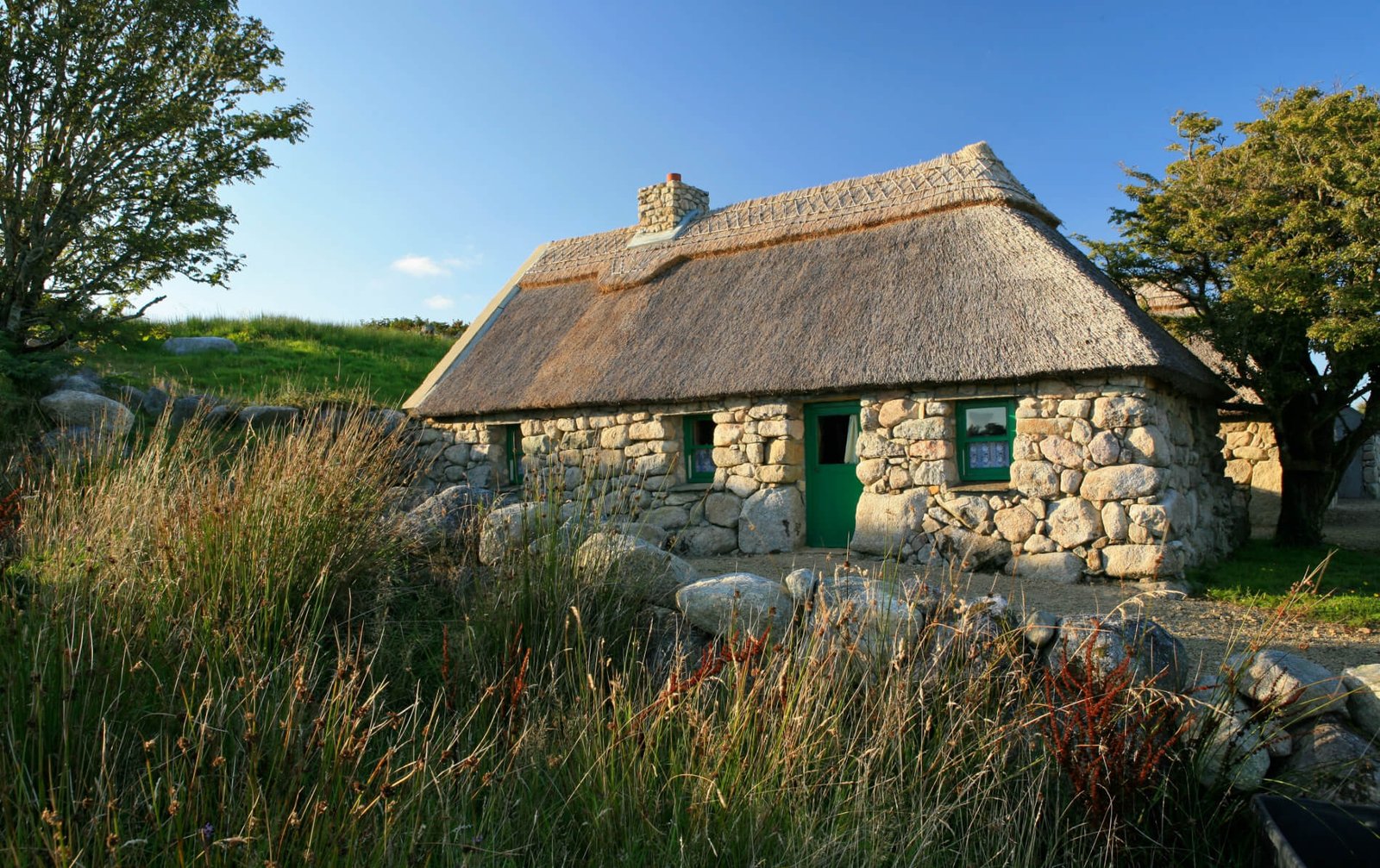 Individual stone and thatched cottages at Mountain Gorilla View Lodge Rwanda